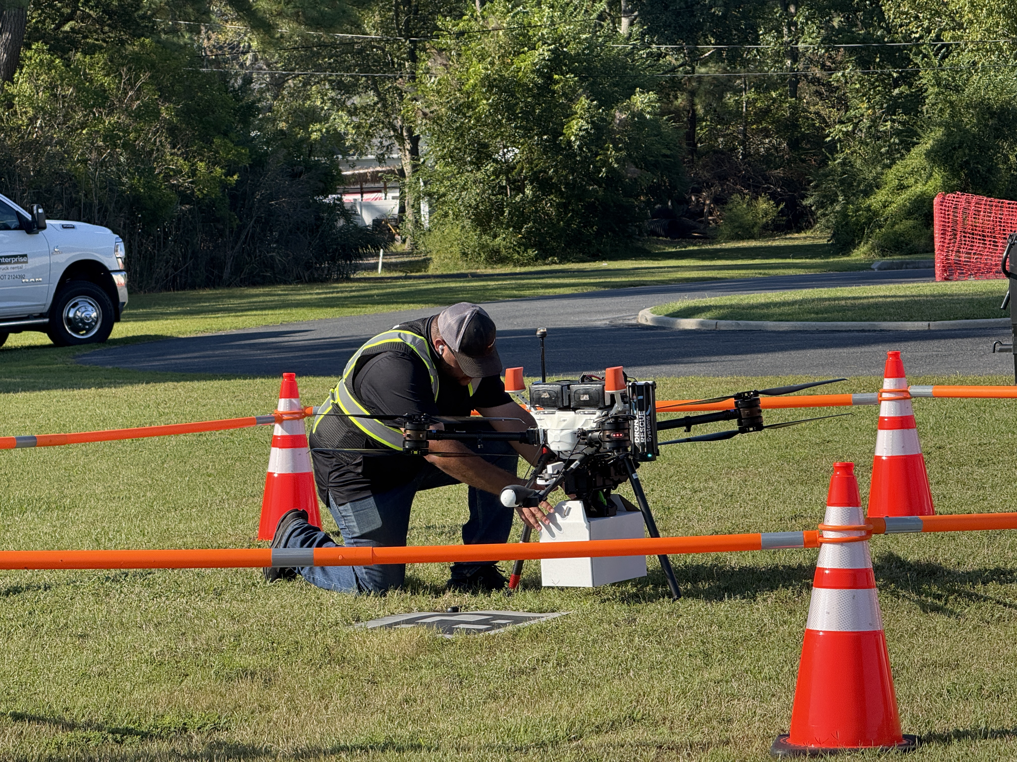 Team member prepares a drone for flight, loading it with a prescription package for delivery during medical drone demonstrations in Crisfield, Md.